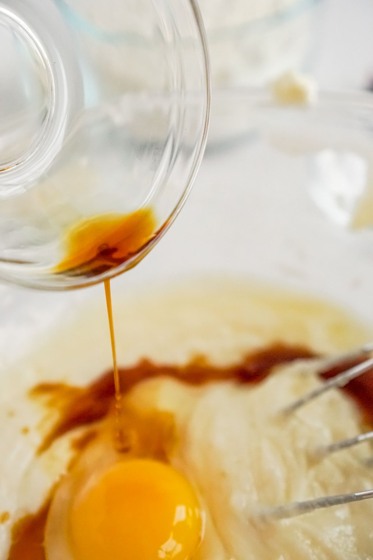 pouring vanilla into a candy cane cookie