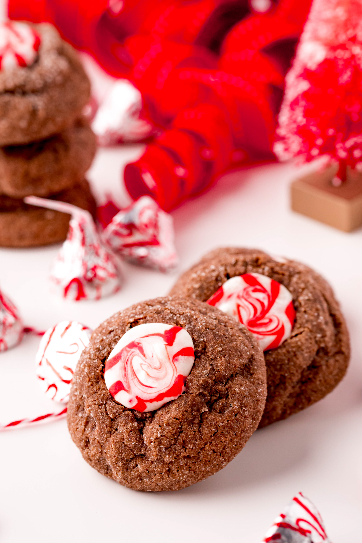 two chocolate peppermint thumbprint cookies stacked