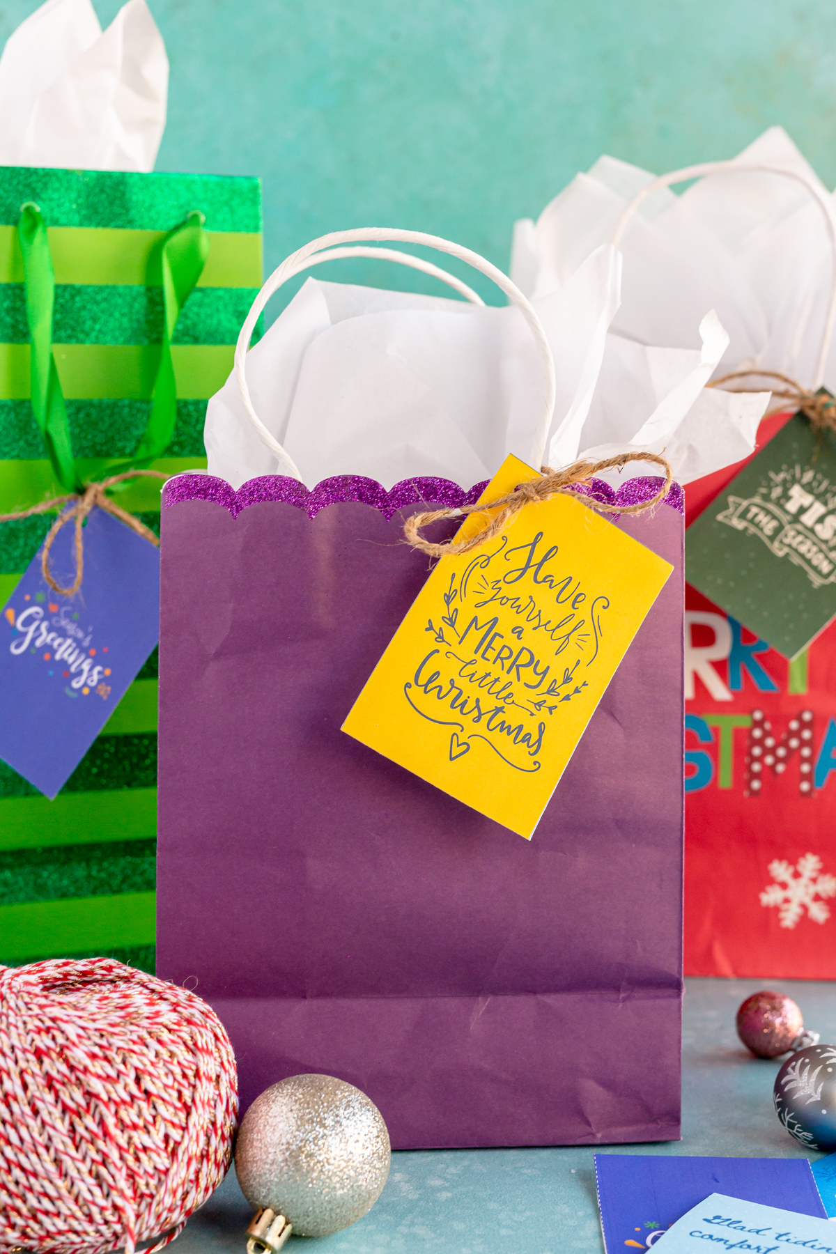 purple gift bag with Christmas gift tags