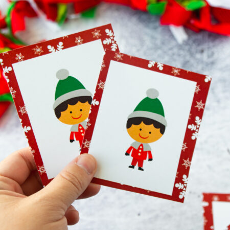 hand holding two Christmas match cards