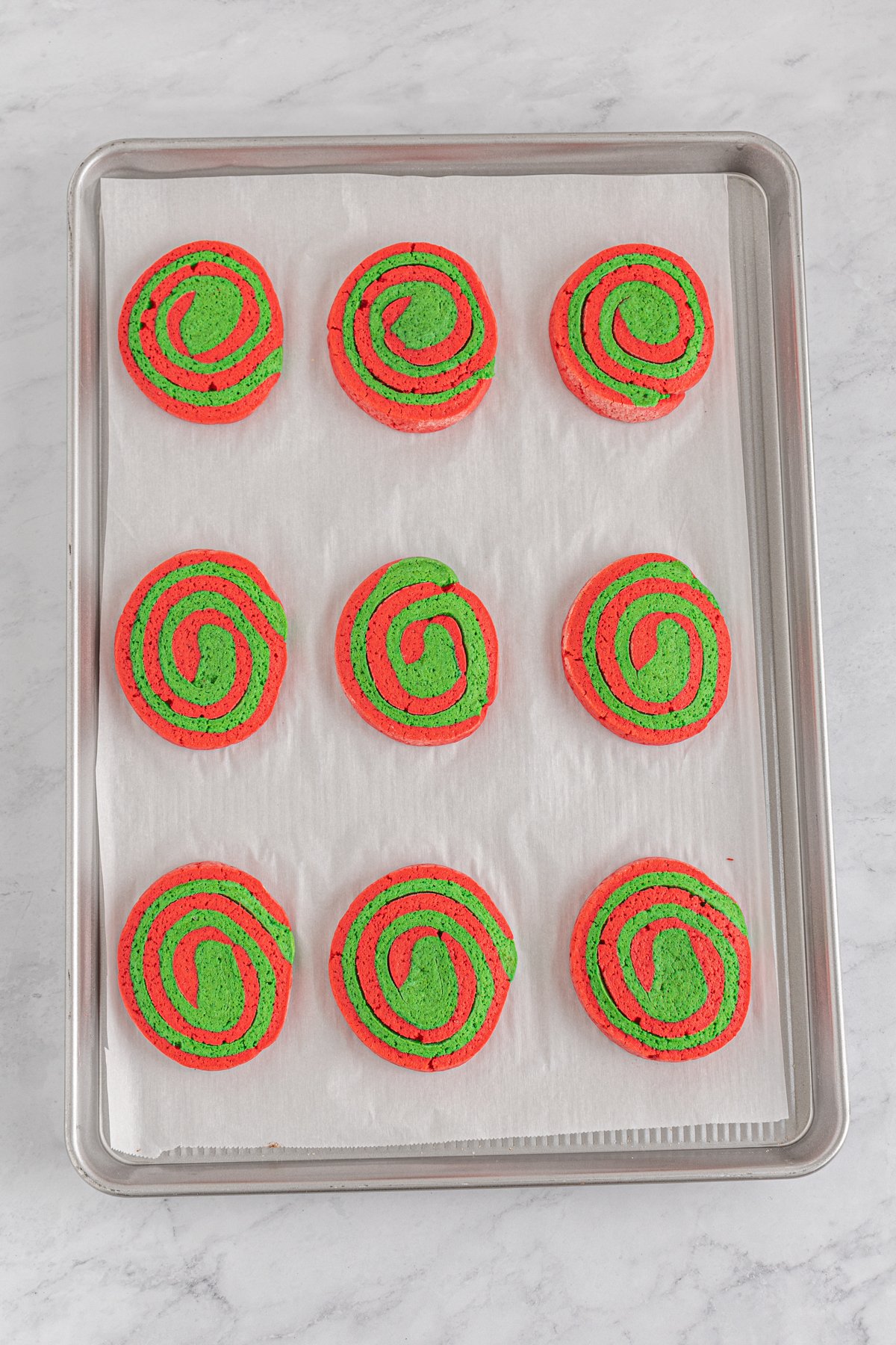 unbaked pinwheel cookies on a baking sheet