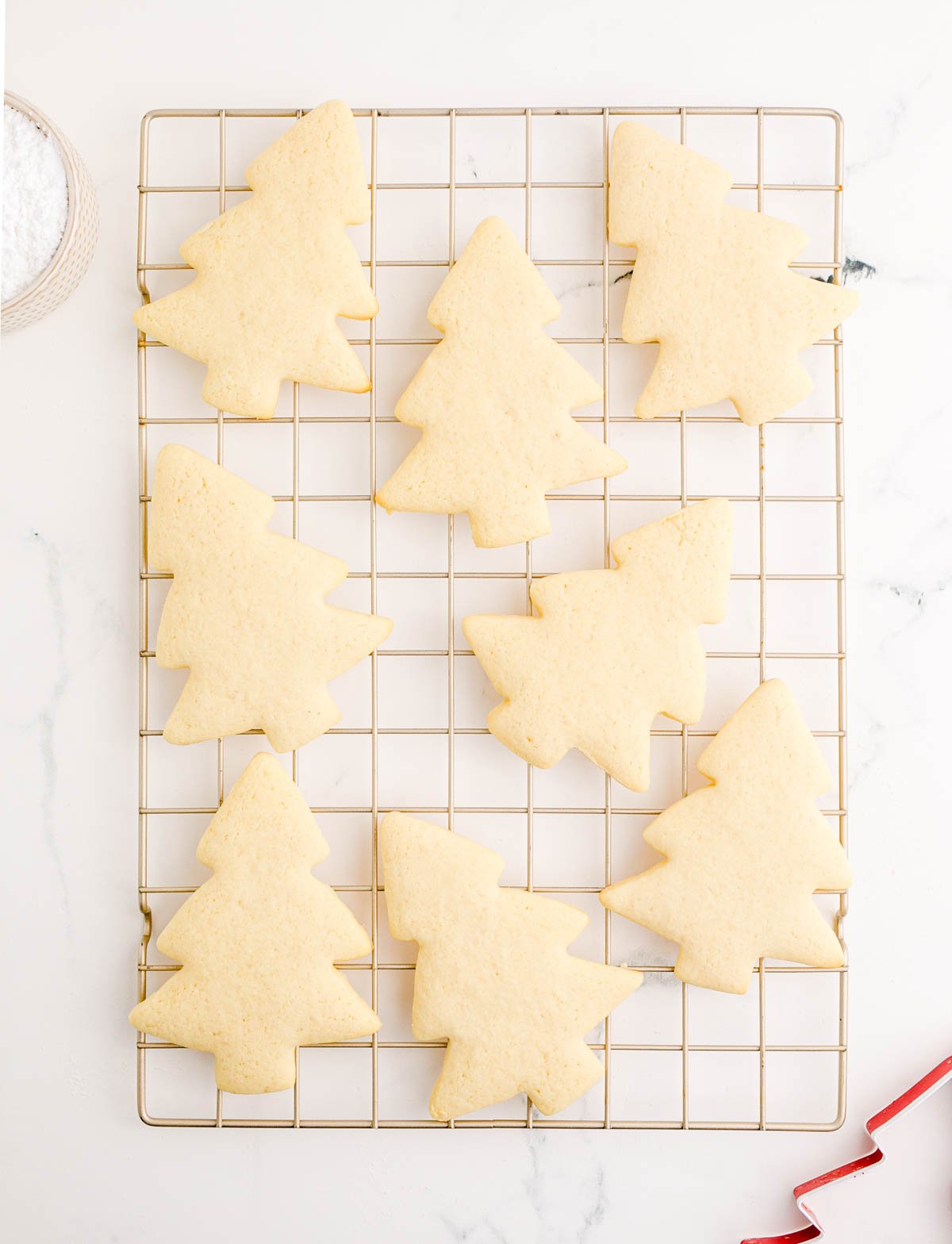 Christmas tree cookies cooling on a wire rack