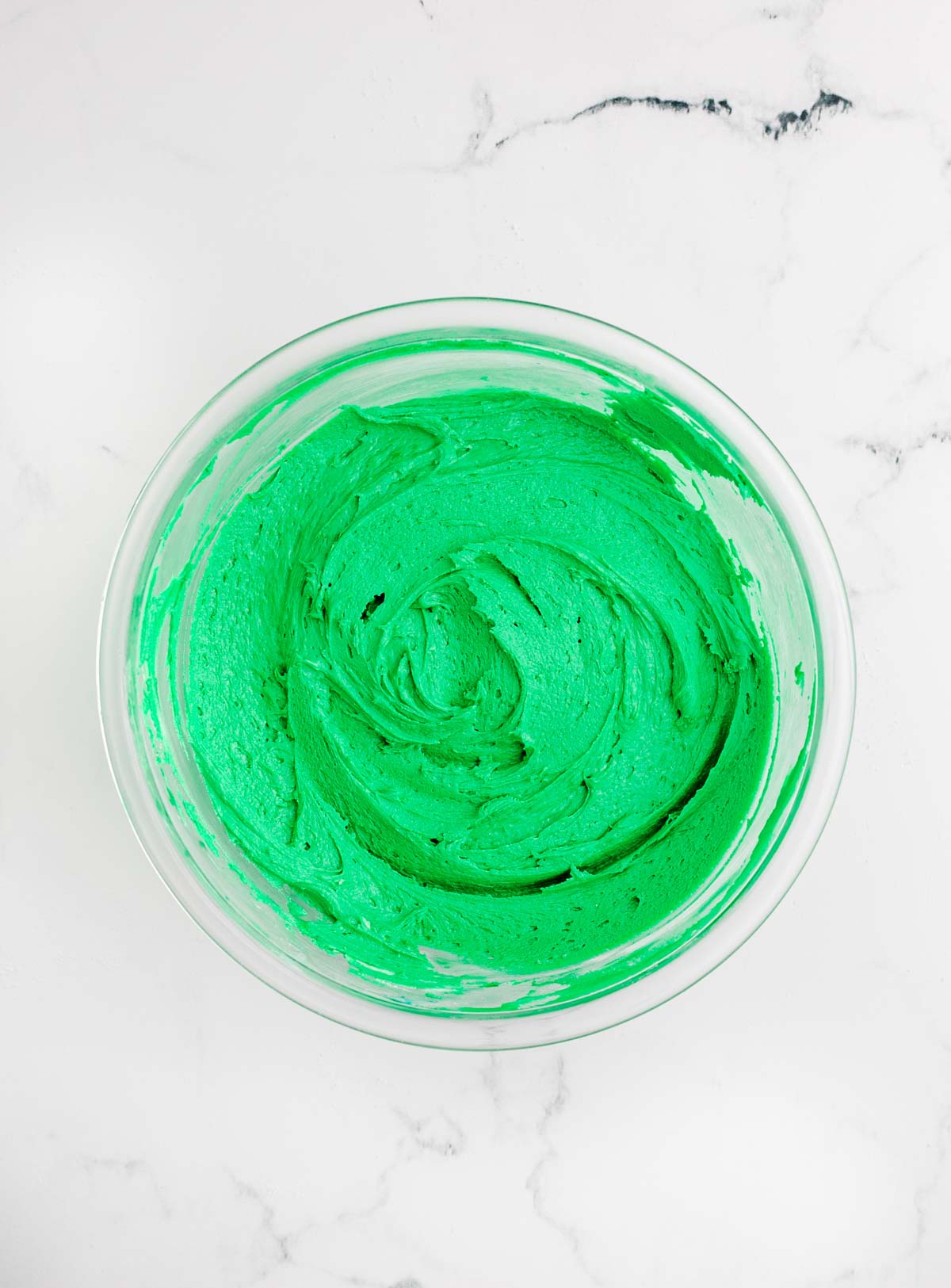 green sugar cookie frosting in a glass bowl