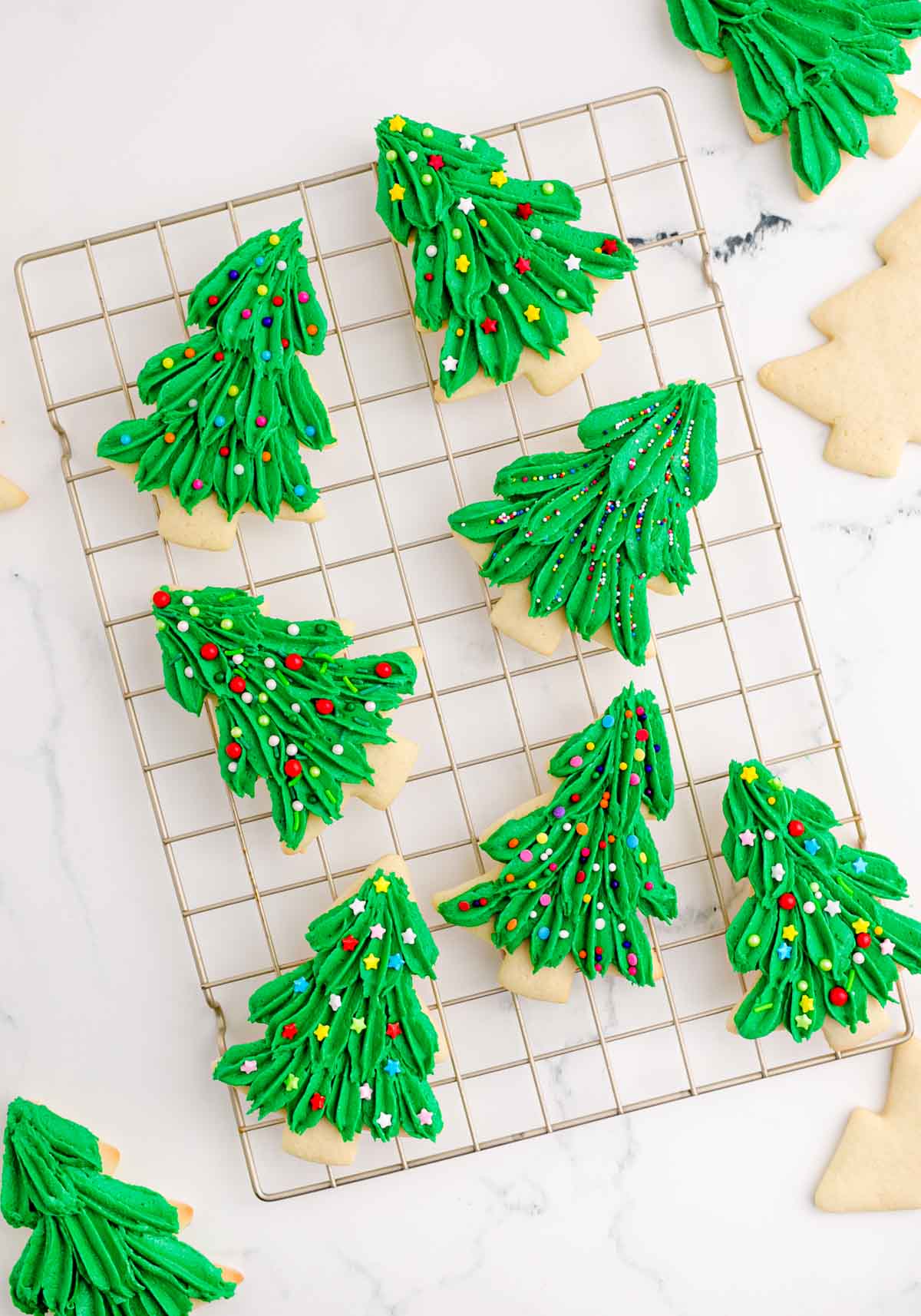 Christmas tree cookies on a wire baking rack