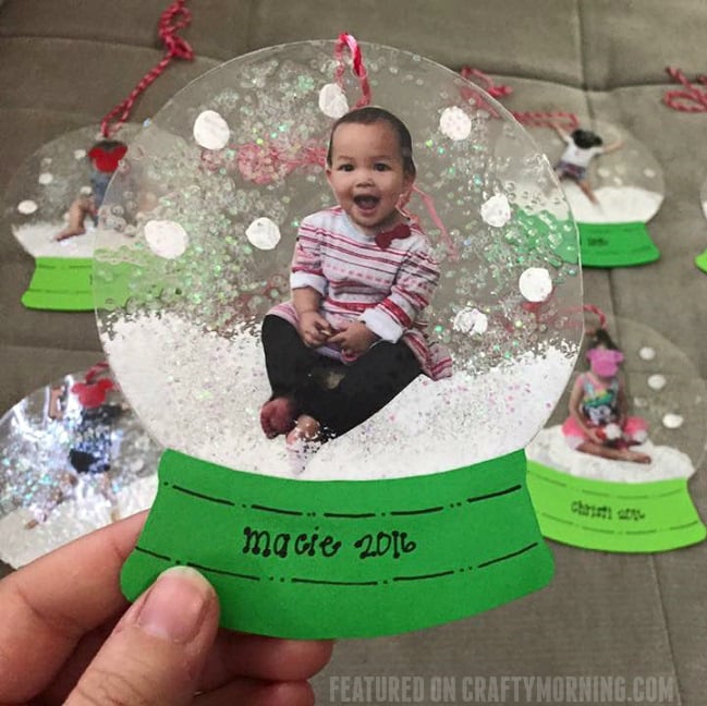 hand holding laminated snow globe ornament