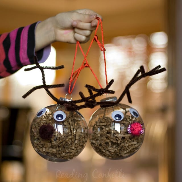 hand holding reindeer ornaments