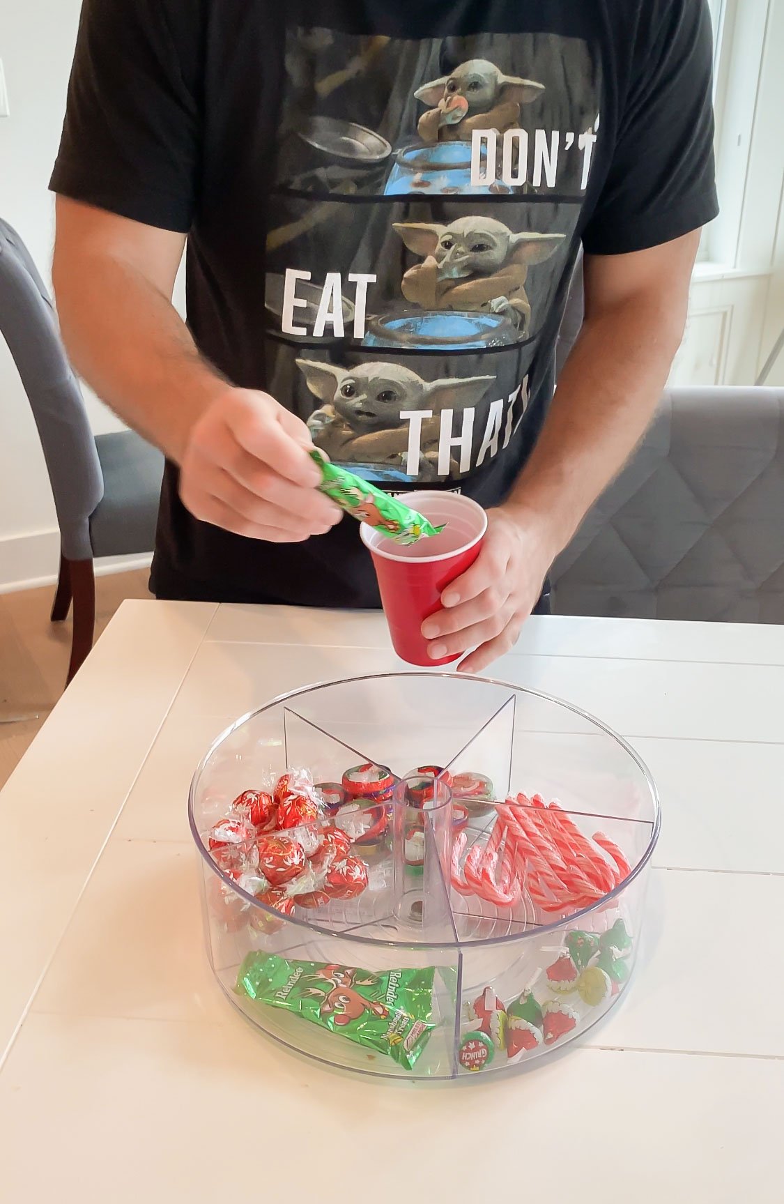 man putting a piece of candy back