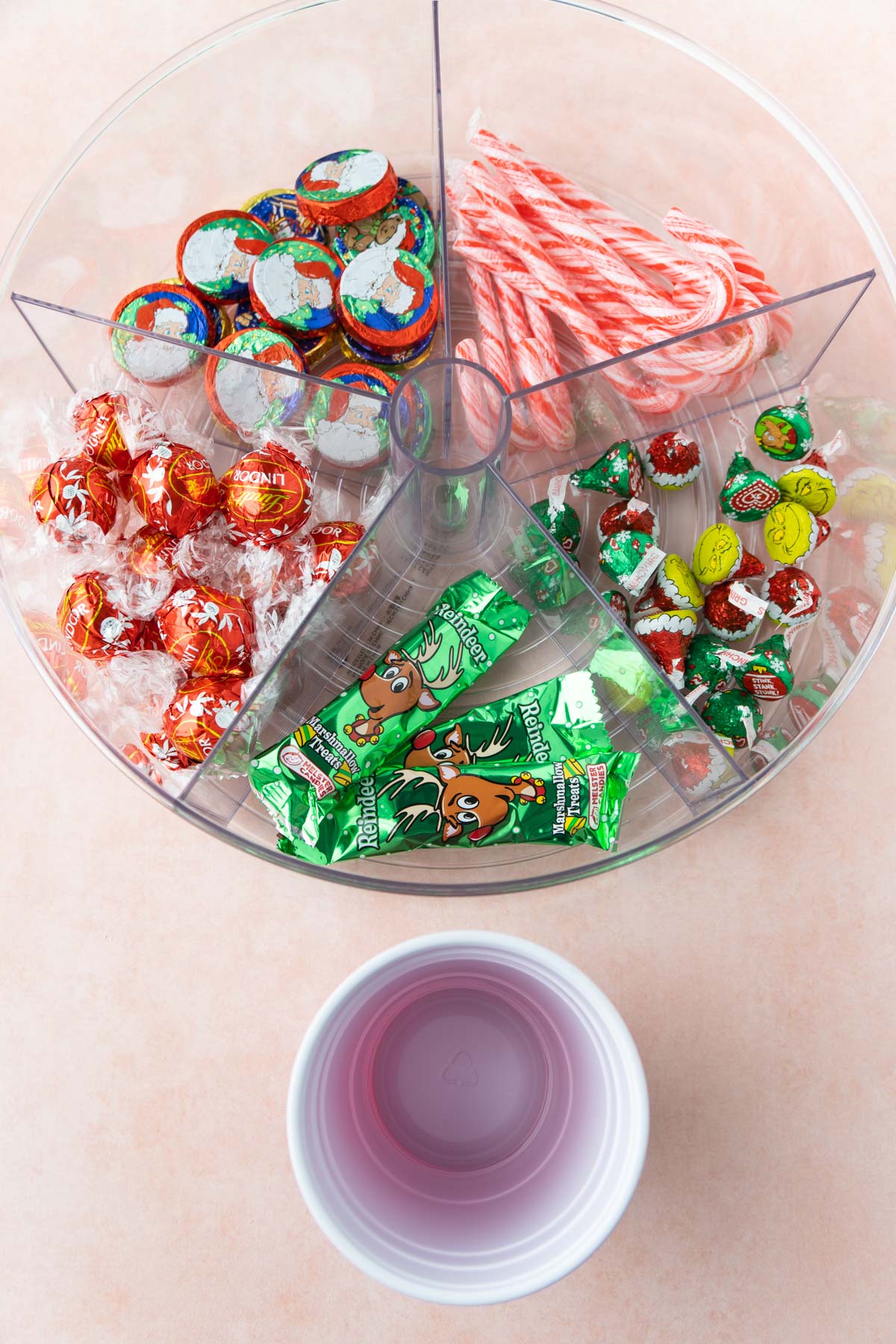 plastic cup by a lazy susan filled with candy