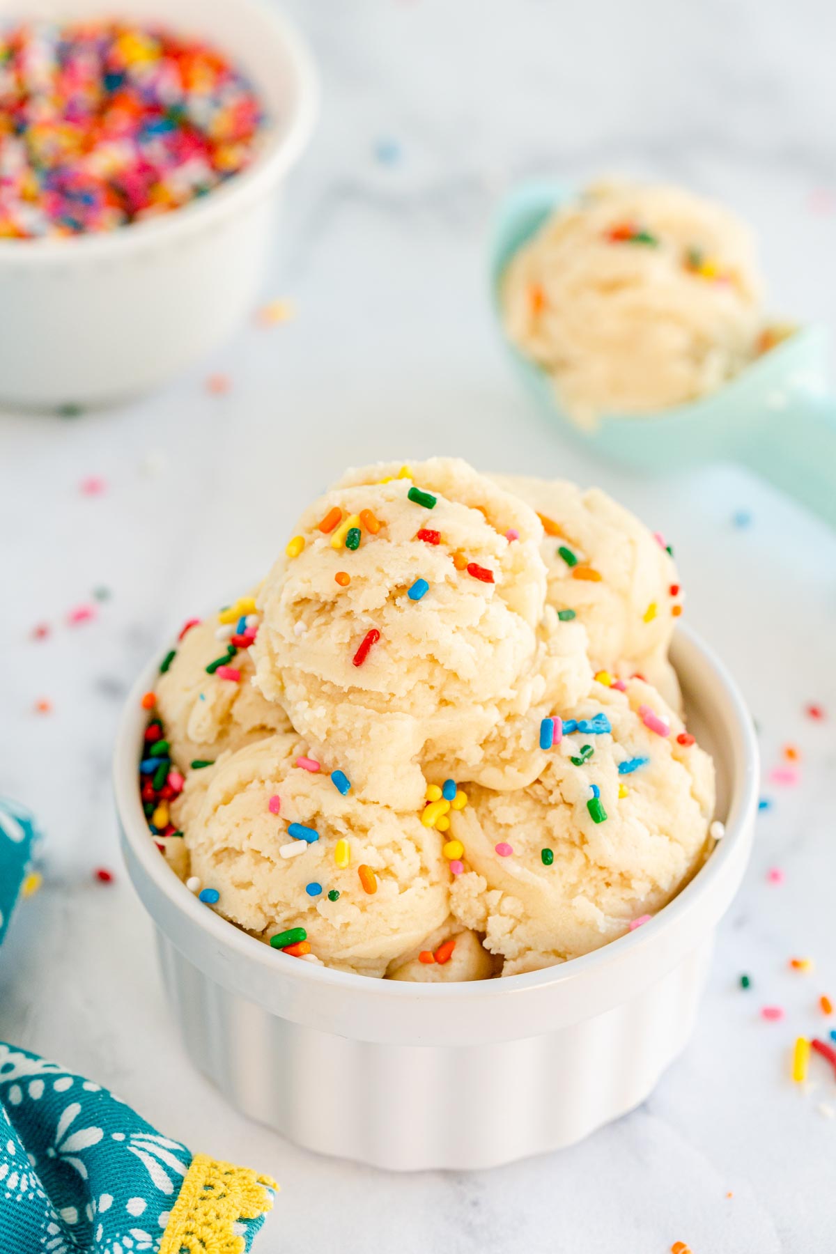 White bowl with scoops of edible sugar cookie dough and sprinkles