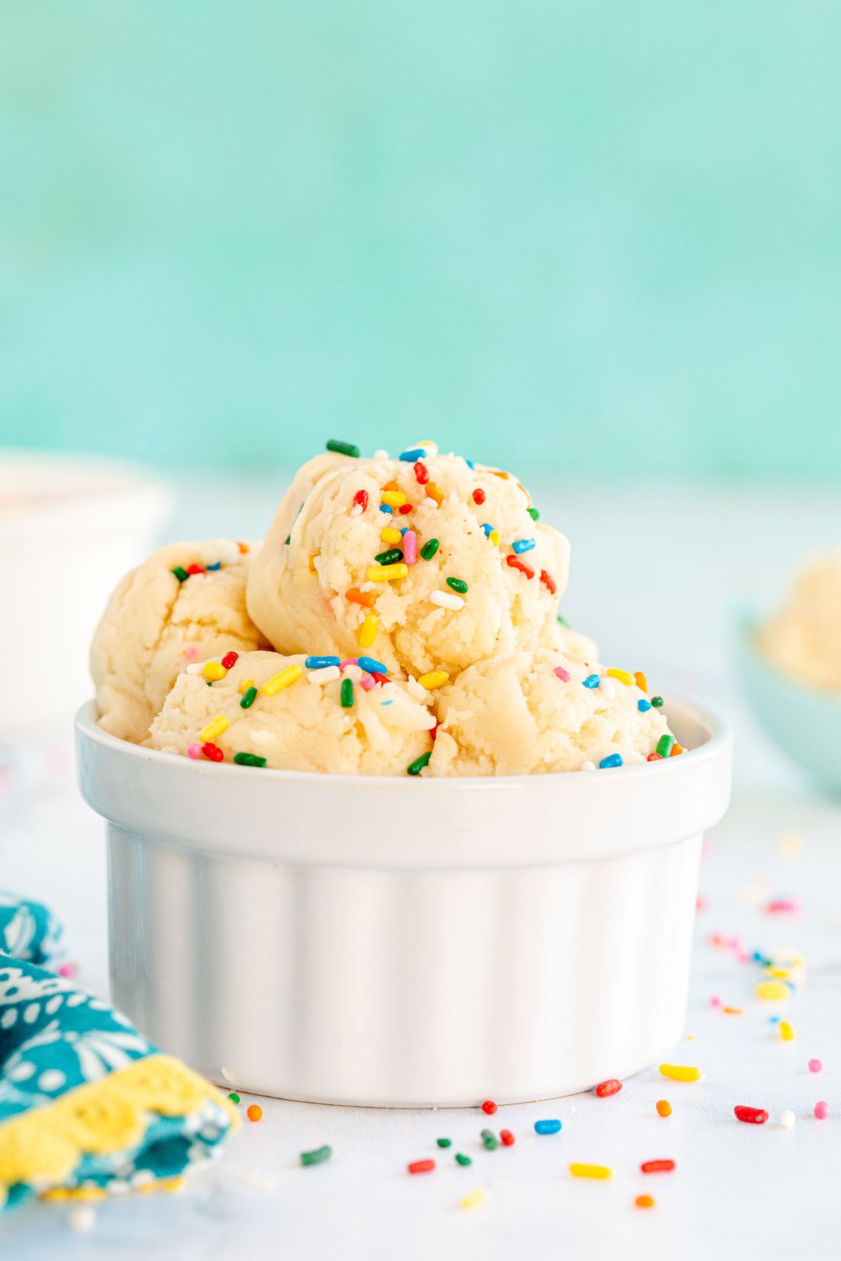 White bowl with edible sugar cookie balls stacked in it