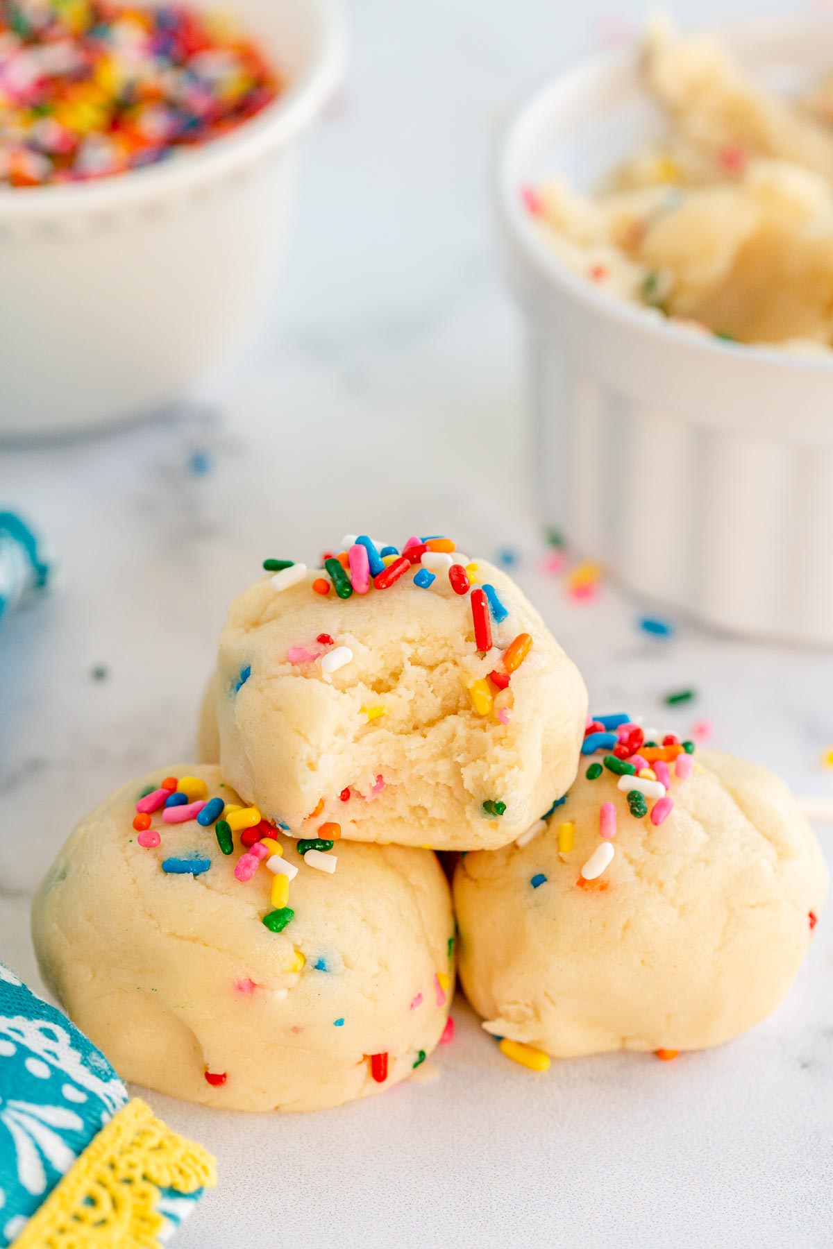 Balls of edible sugar cookie dough with sprinkles