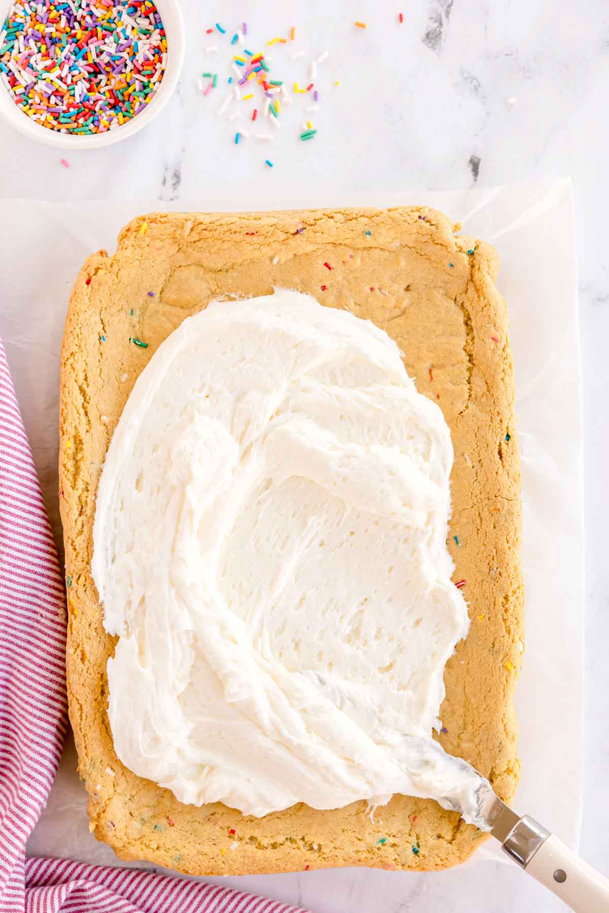sugar cookie bars with vanilla buttercream frosting on top