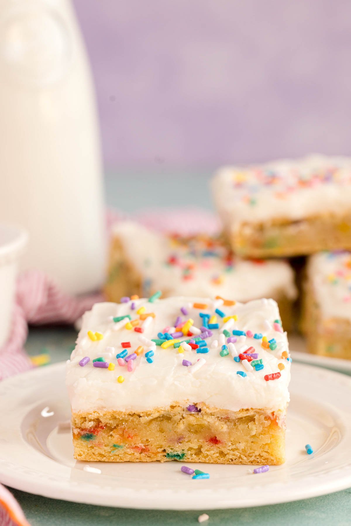 a sugar cookie bar with white buttercream frosting
