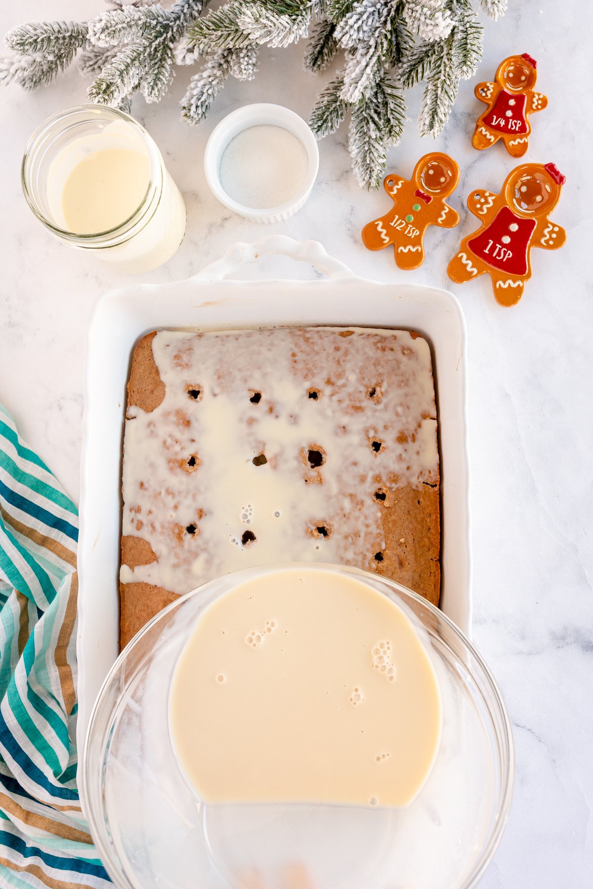 pouring milk over a gingerbread cake