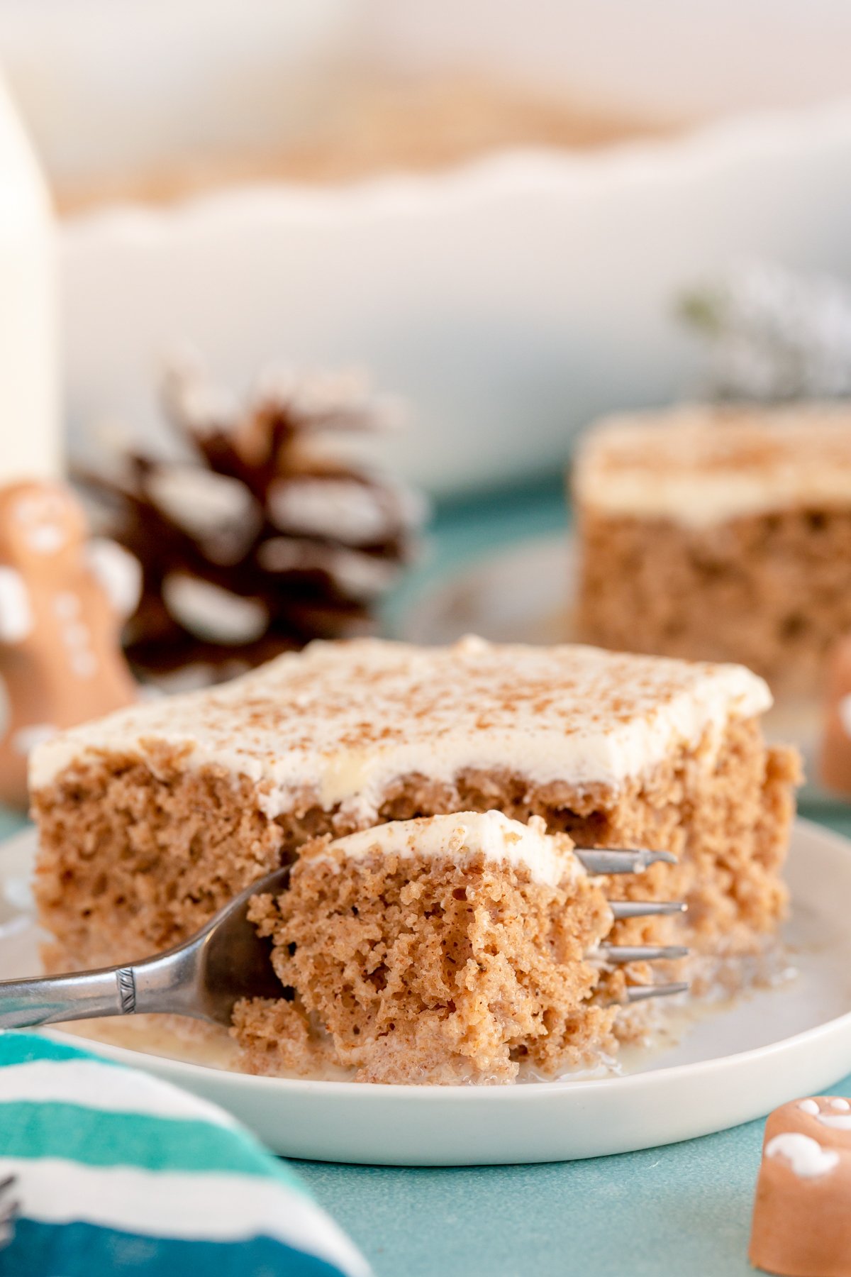 A fork taking a bite of a gingerbread tres leches cake