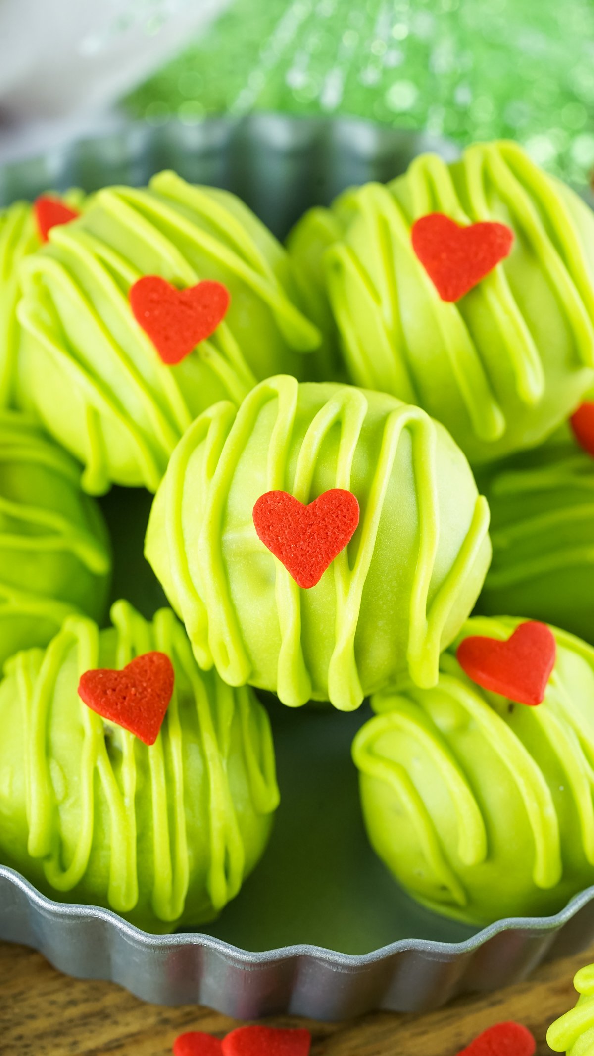 Grinch Christmas balls stacked on a plate