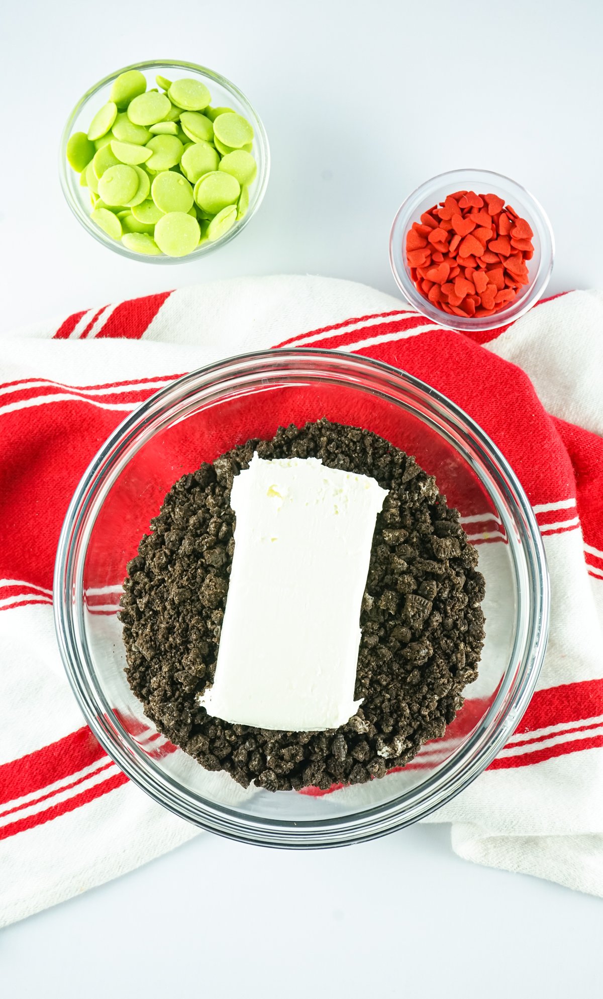 glass bowl with Oreo crumbs and cream cheese