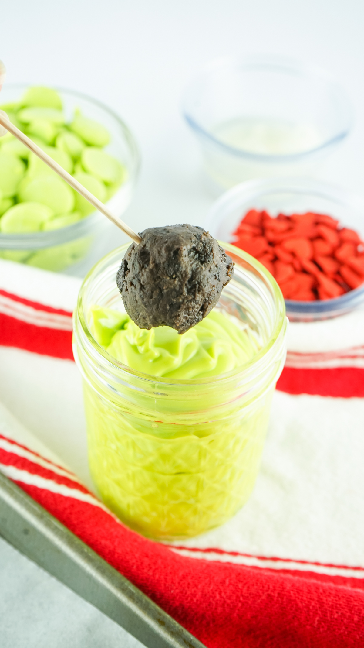 dipping Oreo balls in melted green candy melts