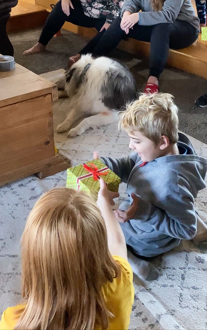 kids passing a green gift box to each other