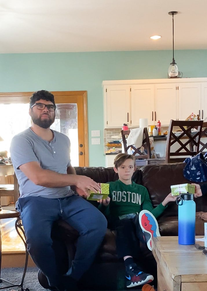 man and teen passing gifts to each other