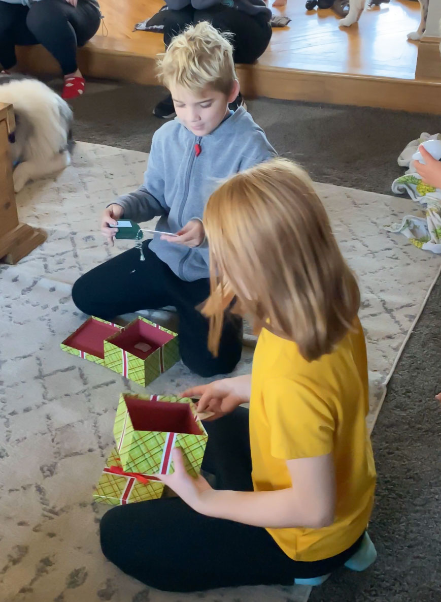 kids opening green gift boxes