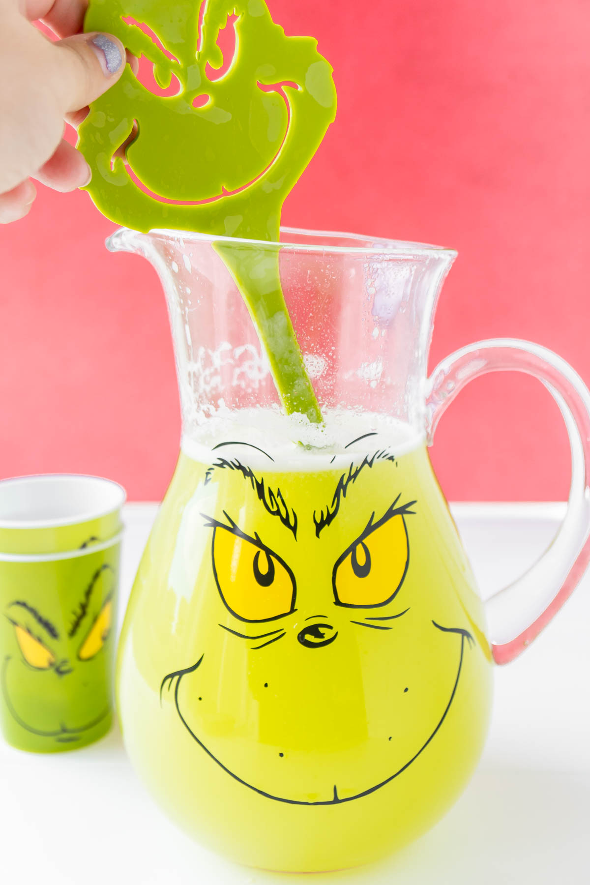 Grinch spatula mixing up a Grinch punch