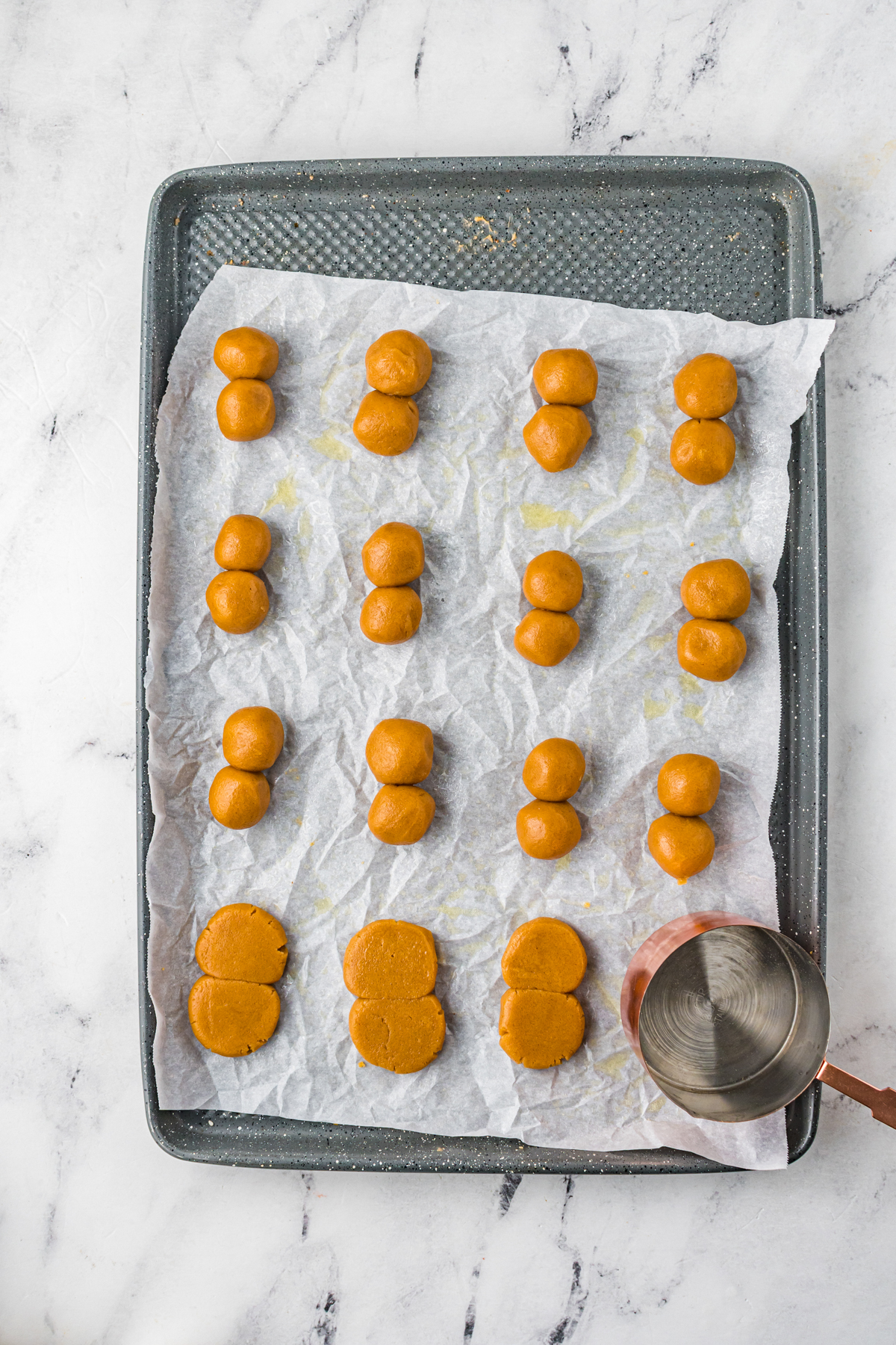 peanut butter balls on a baking sheet