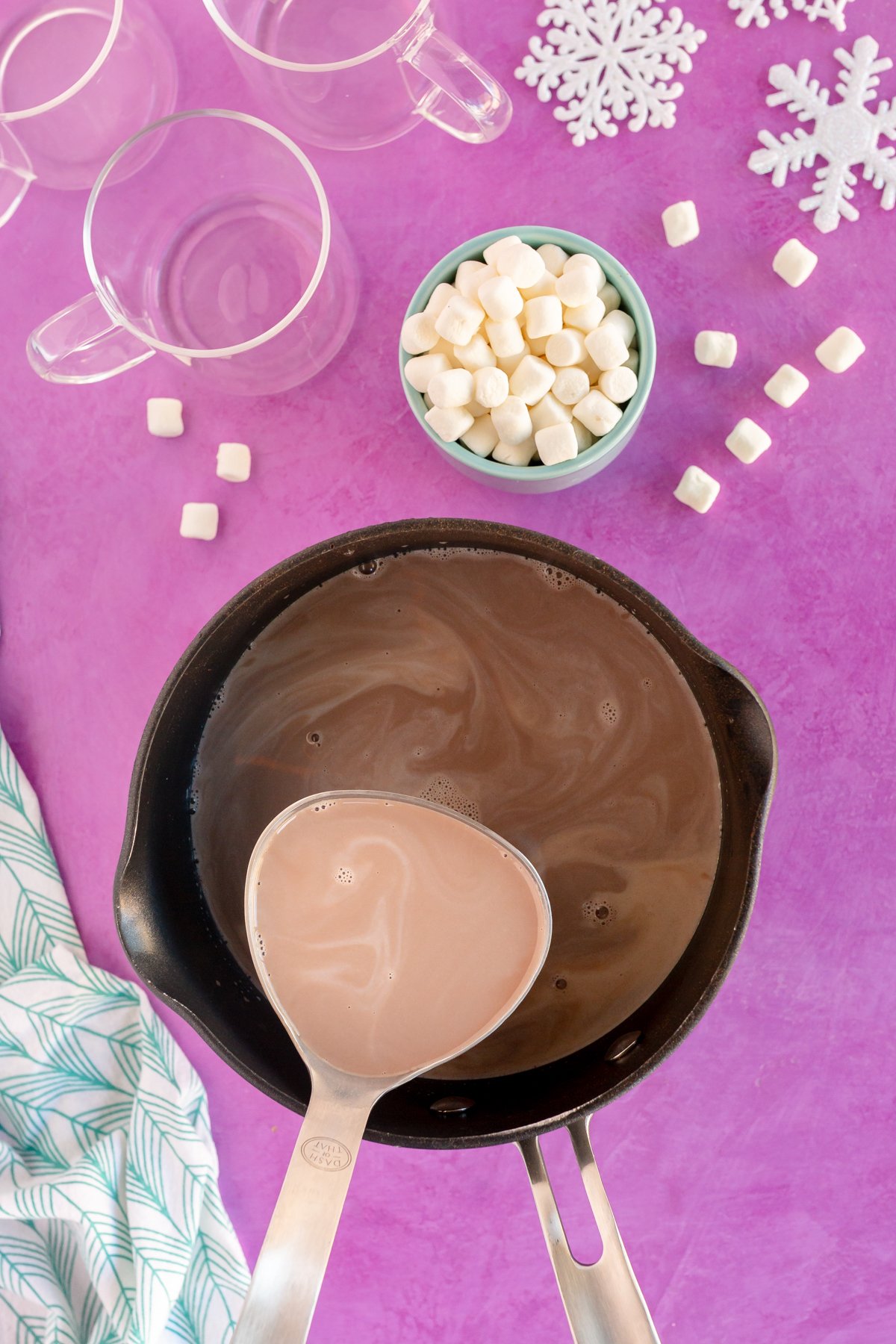 ladle of hot chocolate above a pot of homemade hot chocolate