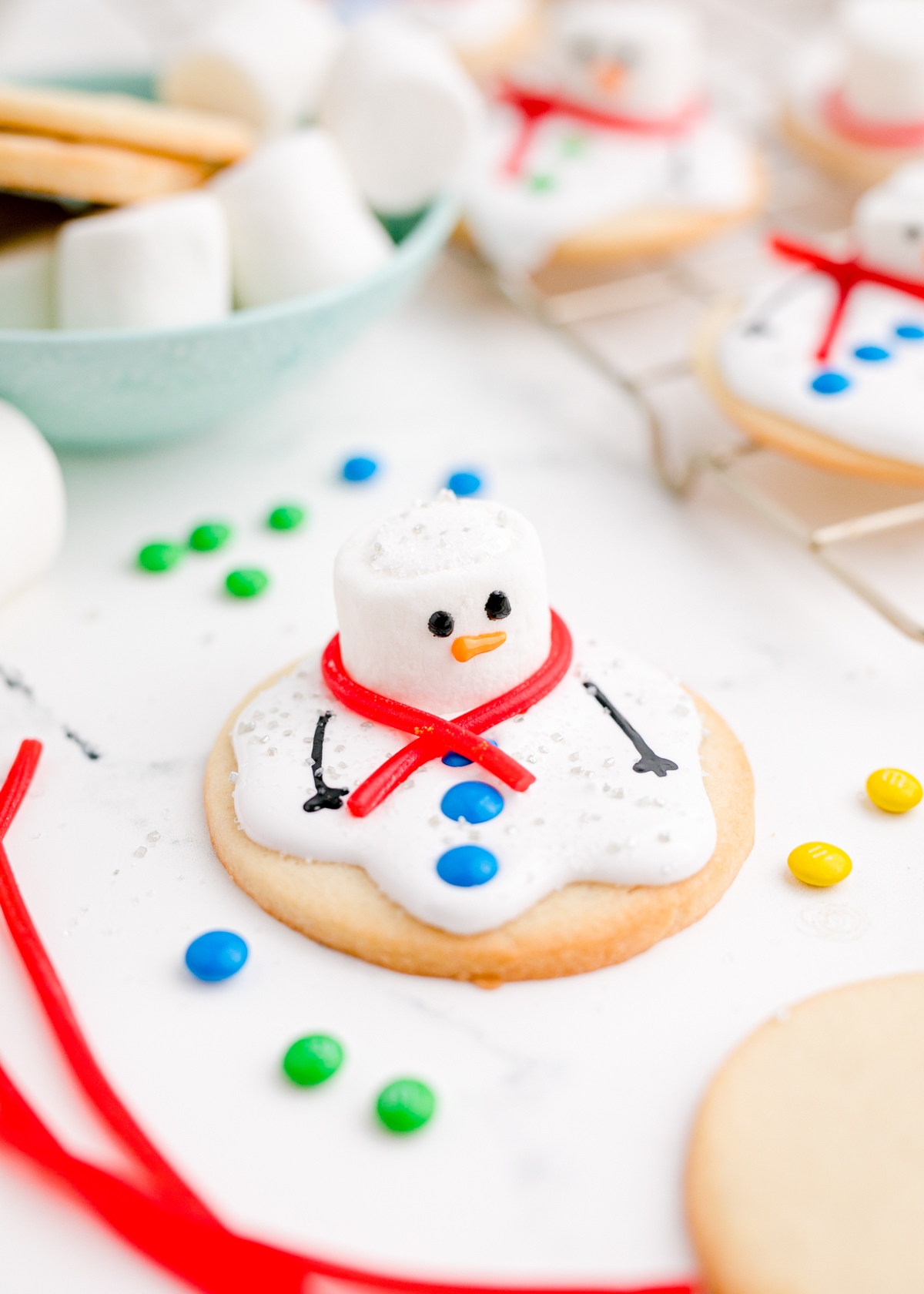 melted snowman cookies with candy all around
