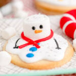 Melted snowman cookie on a blue napkin