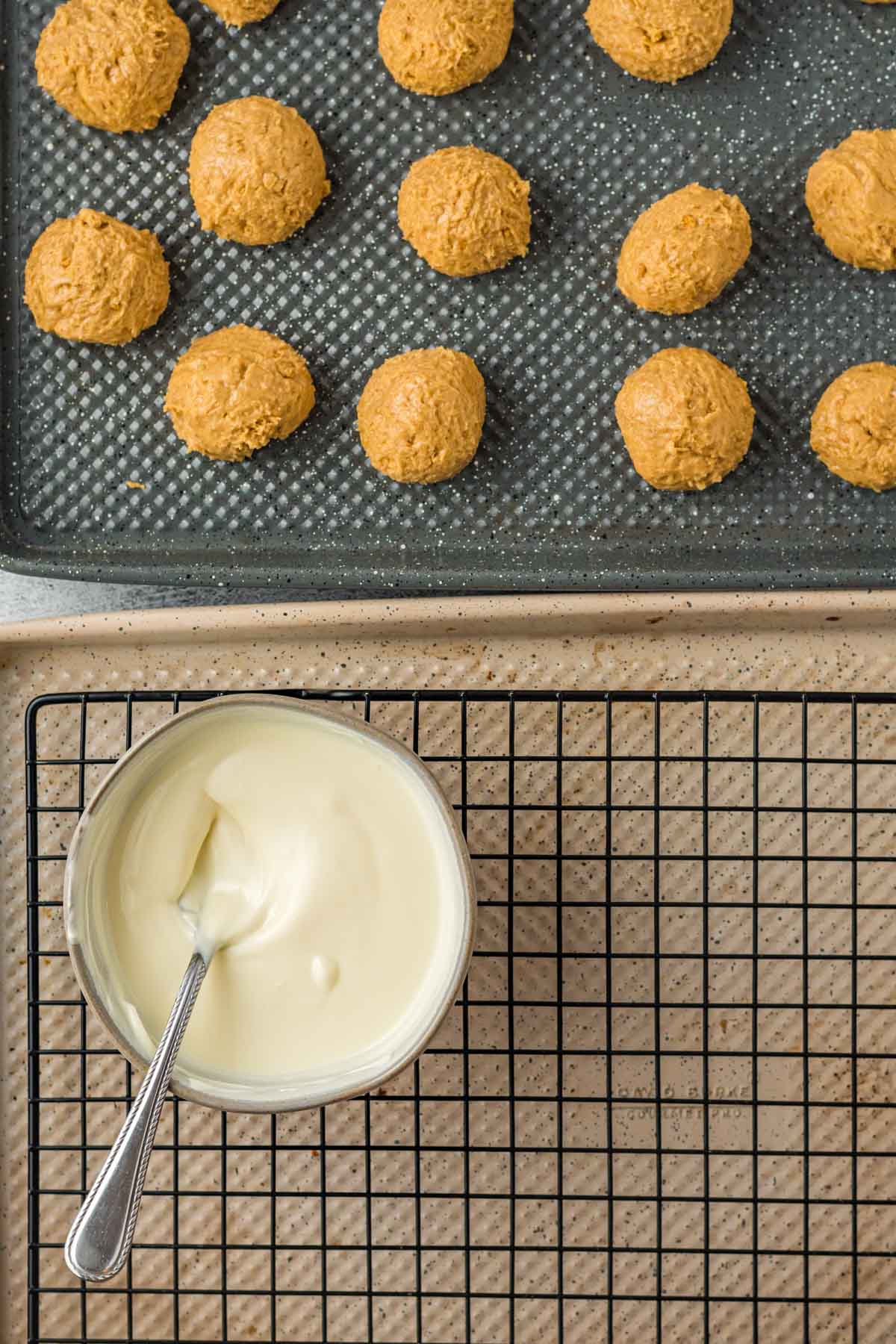 uncoated peanut butter snowballs on a baking sheet