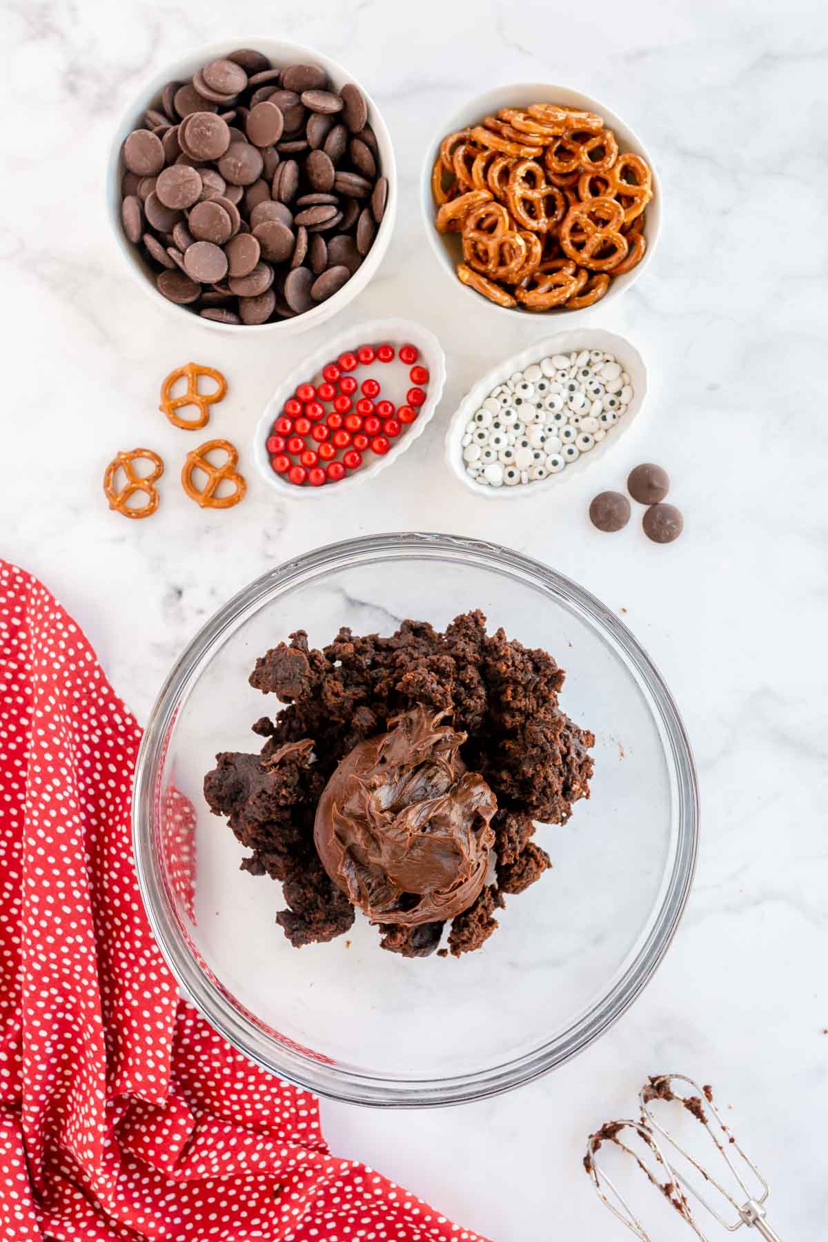 chocolate frosting in a bowl with brownies