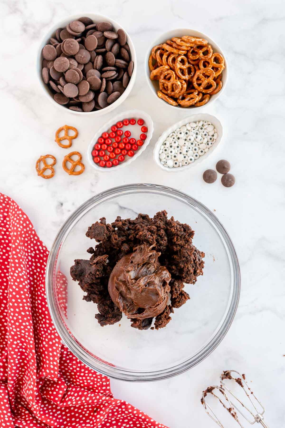 chocolate frosting in a bowl with brownies