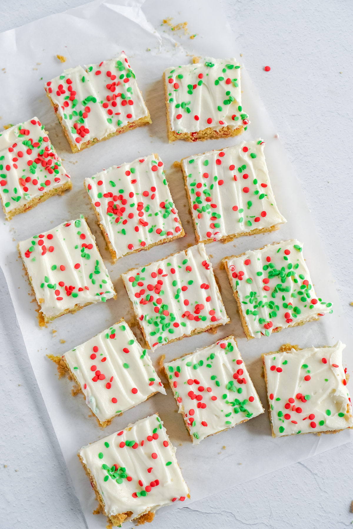 Christmas sugar cookie bars on a piece of parchment paper