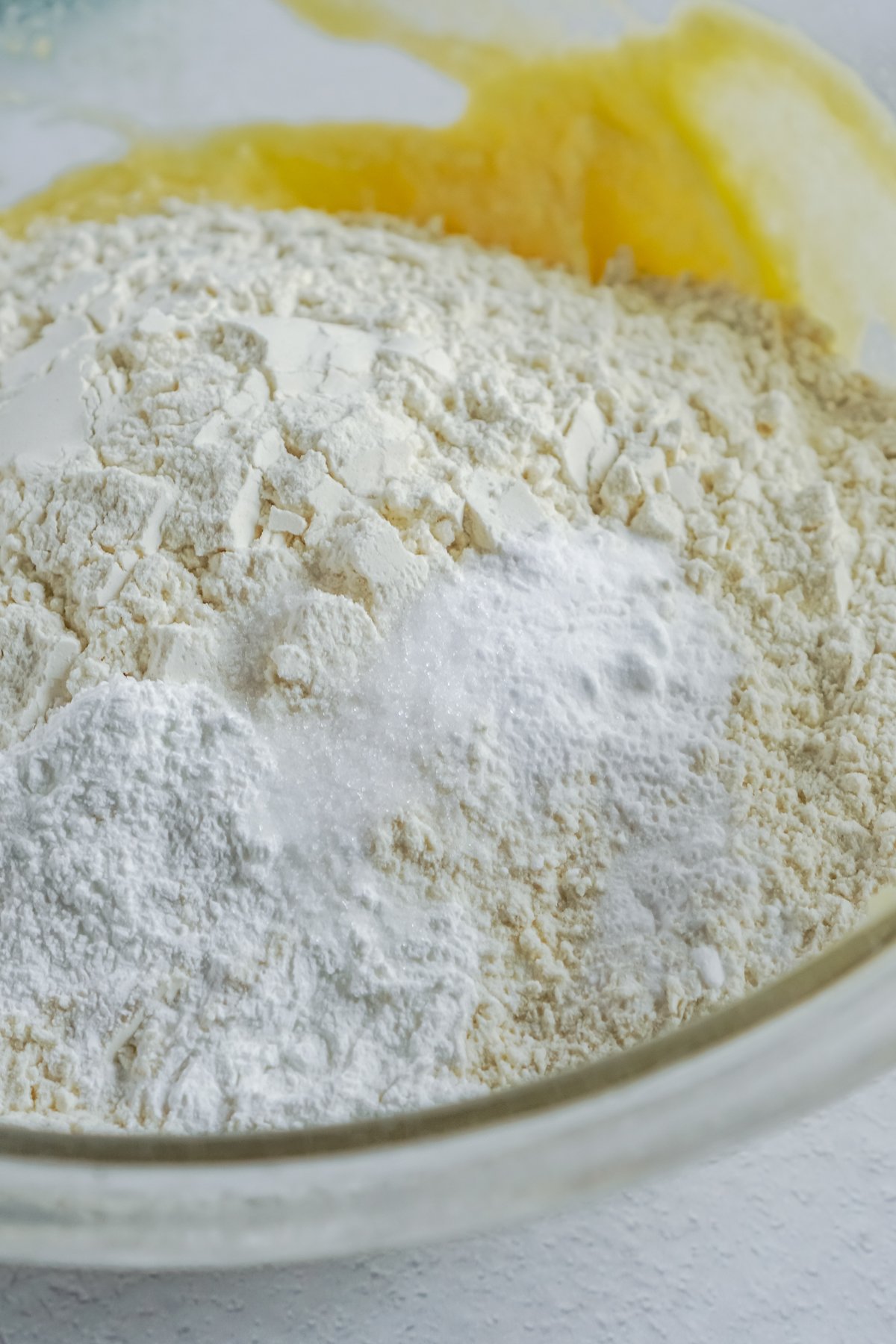 glass bowl with flour and sugar in it