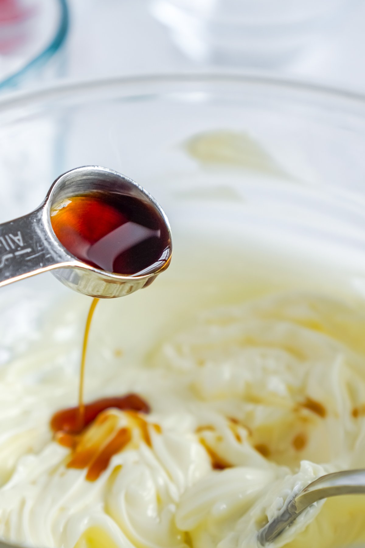 vanilla being added to buttercream frosting