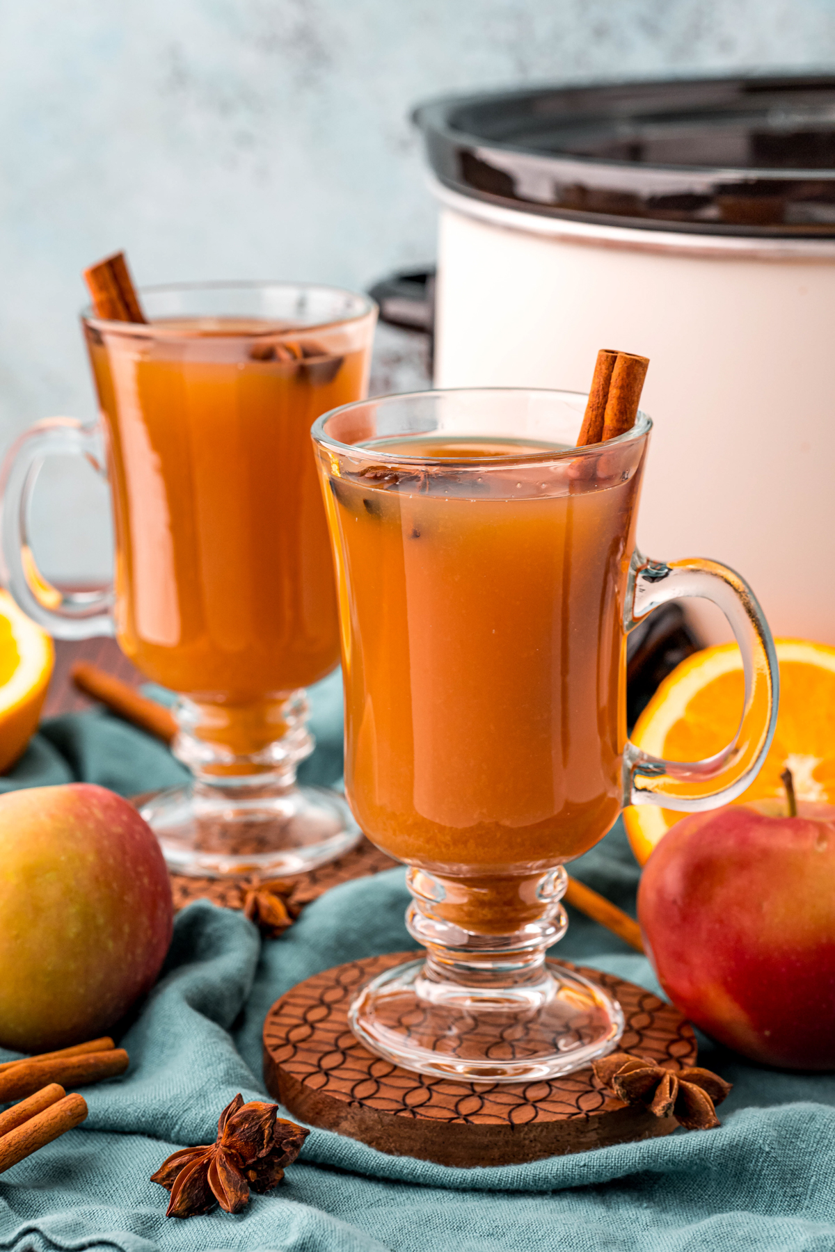 two large glasses of wassail with cinnamon sticks