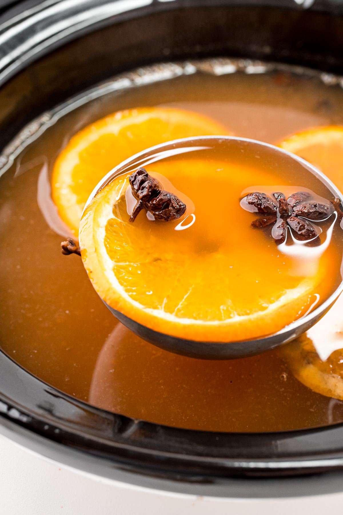 ladle with a scoop of hot wassail