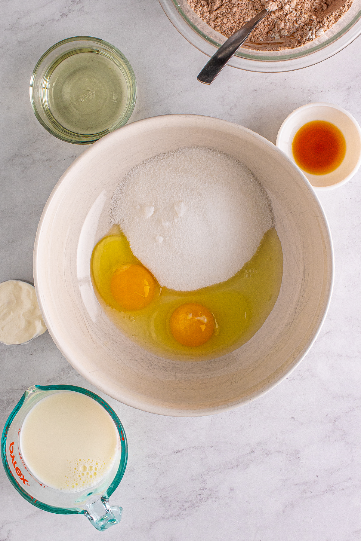 eggs and sugar in a white bowl