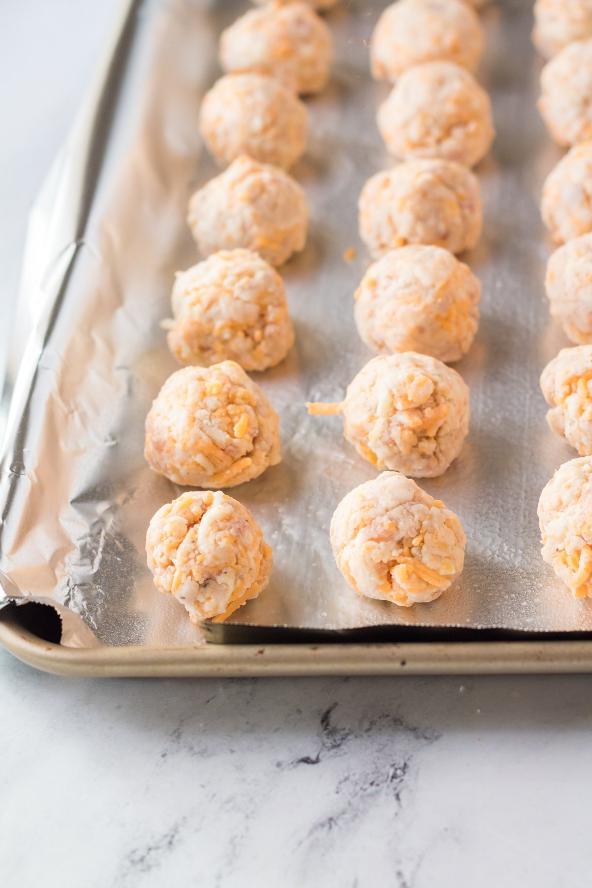 baking sheet with Bisquick sausage balls lined up