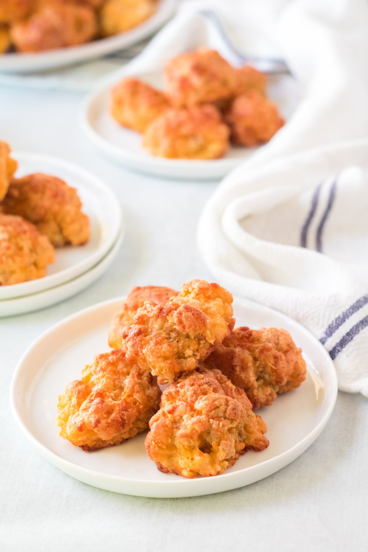 white plates with Bisquick sausage balls stacked on them