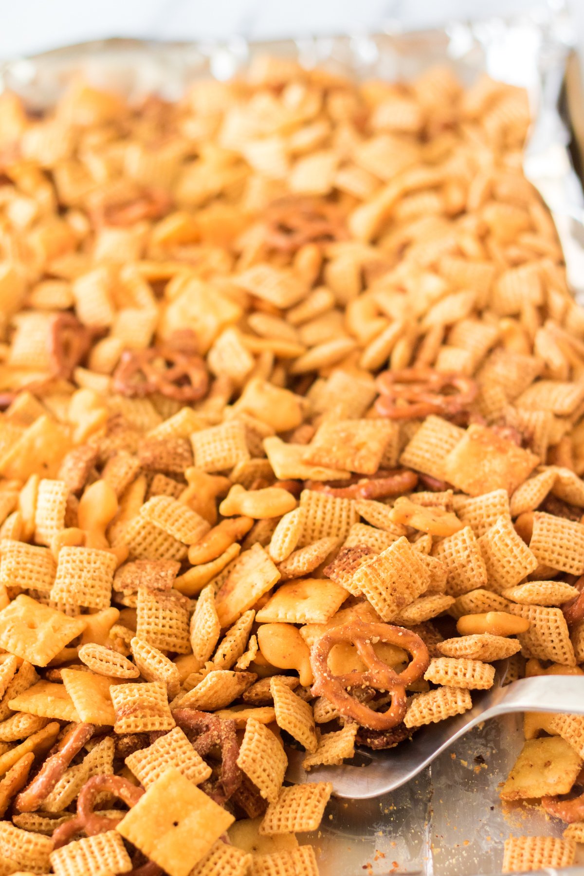 spatula stirring cheddar chex mix