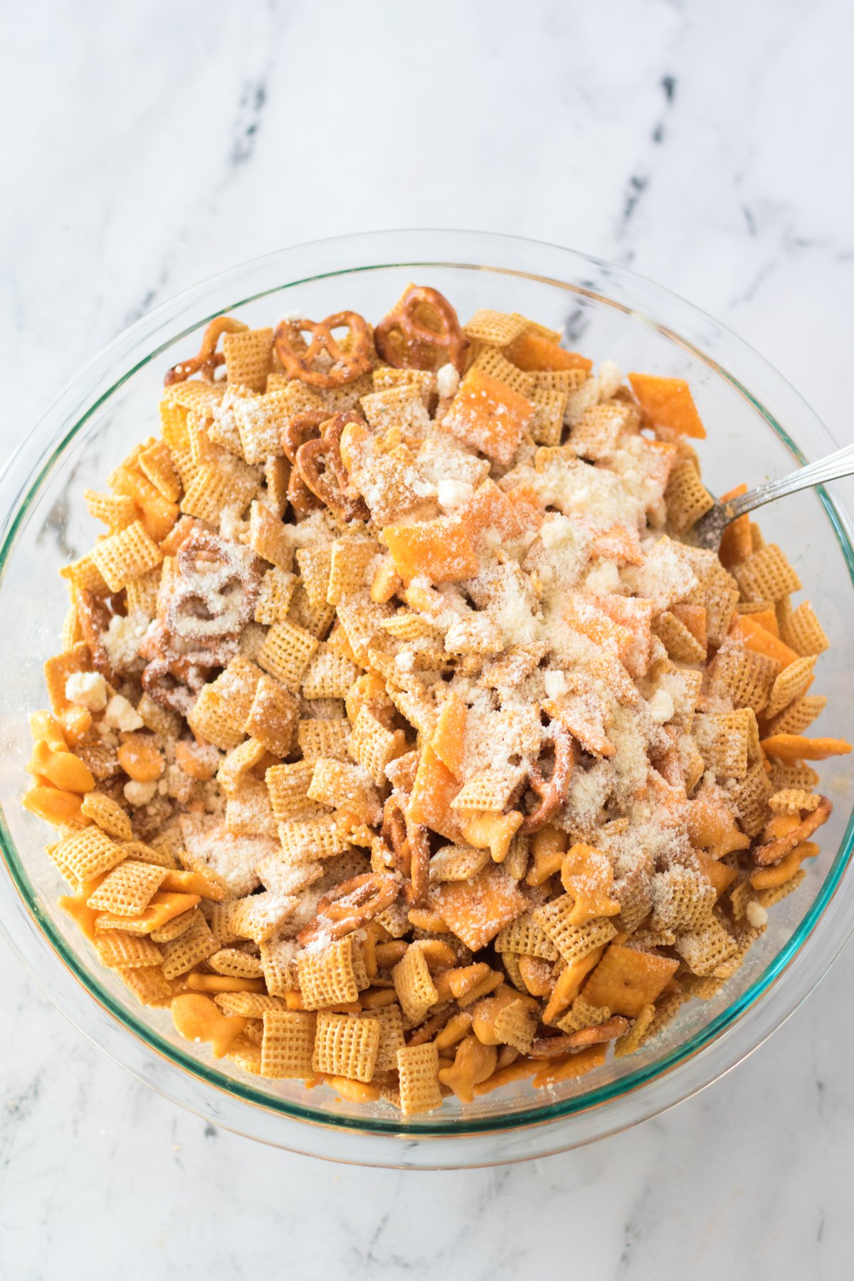 glass bowl with cheddar chex mix ingredients