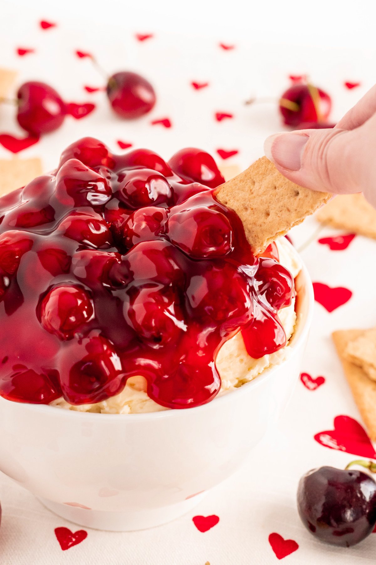 graham cracker in cherry cheesecake dip