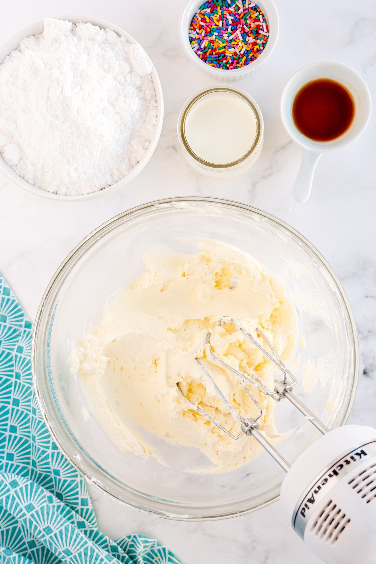 butter and cream cheese mixed together in a glass bowl