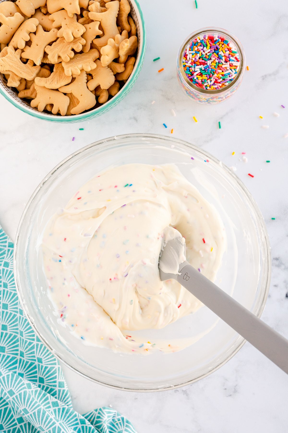 folding funfetti sprinkles into a funfetti dip