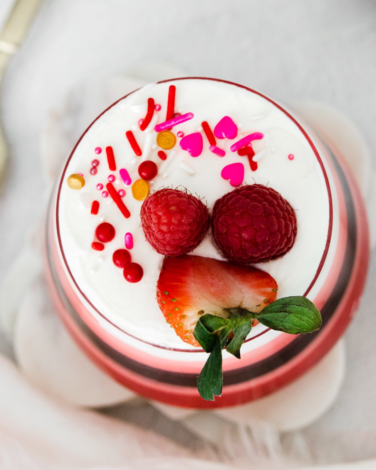 layered jello dessert topped with whipped cream