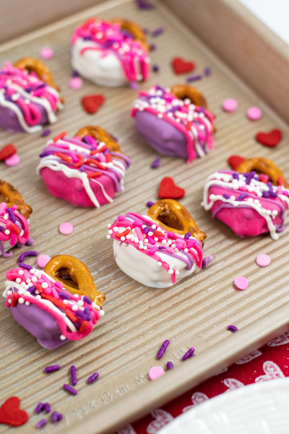 decorated Valentine's Day pretzels on a baking sheet