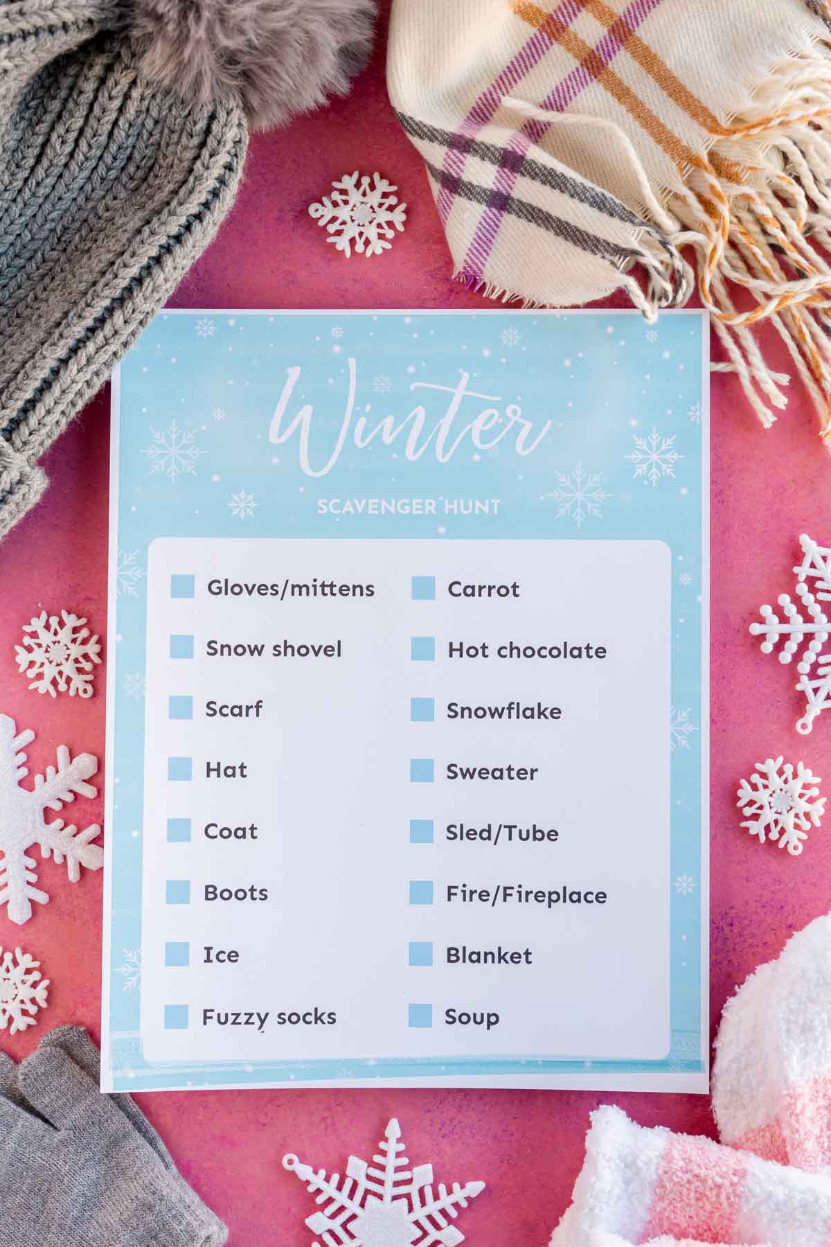printed out winter scavenger hunt with winter gear all around