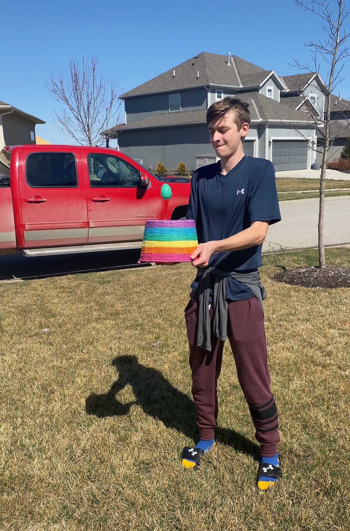 teen boy holding an Easter basket upside down